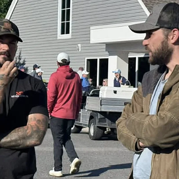 Team members talking outside at a community event