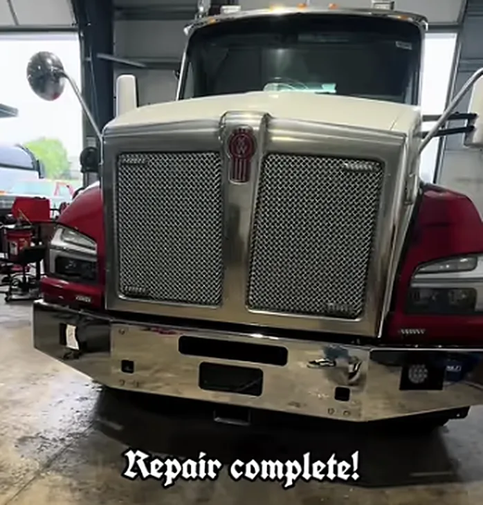 A red semi truck in the shop after a completed repair