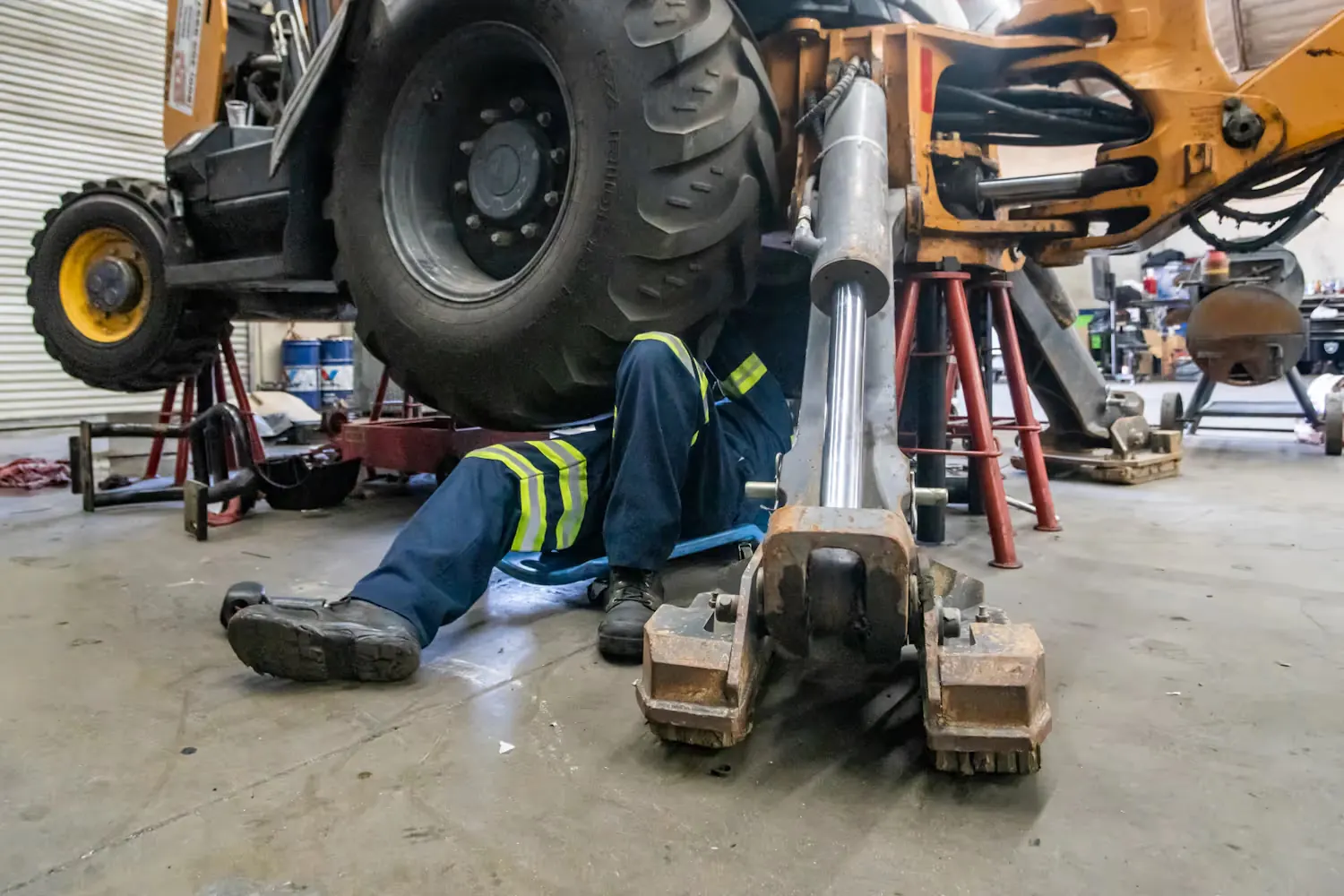 Mechanic working underneath a piece of heavy equipment