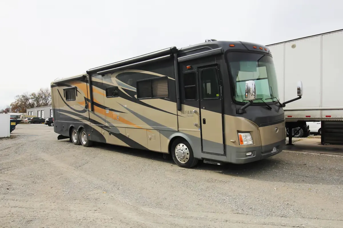 A diesel motorhome parked outside a repair shop